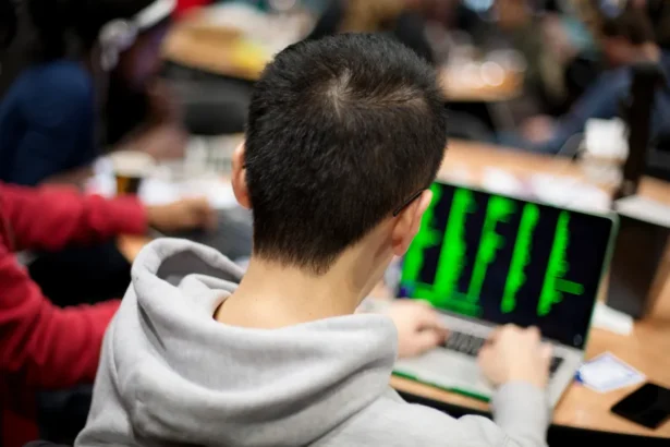 A group of children learning to code at an EU Code Week event.