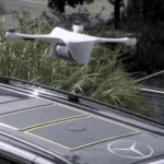 A Mercedes-Benz van in Zurich, Switzerland, with a drone landing on its roof.